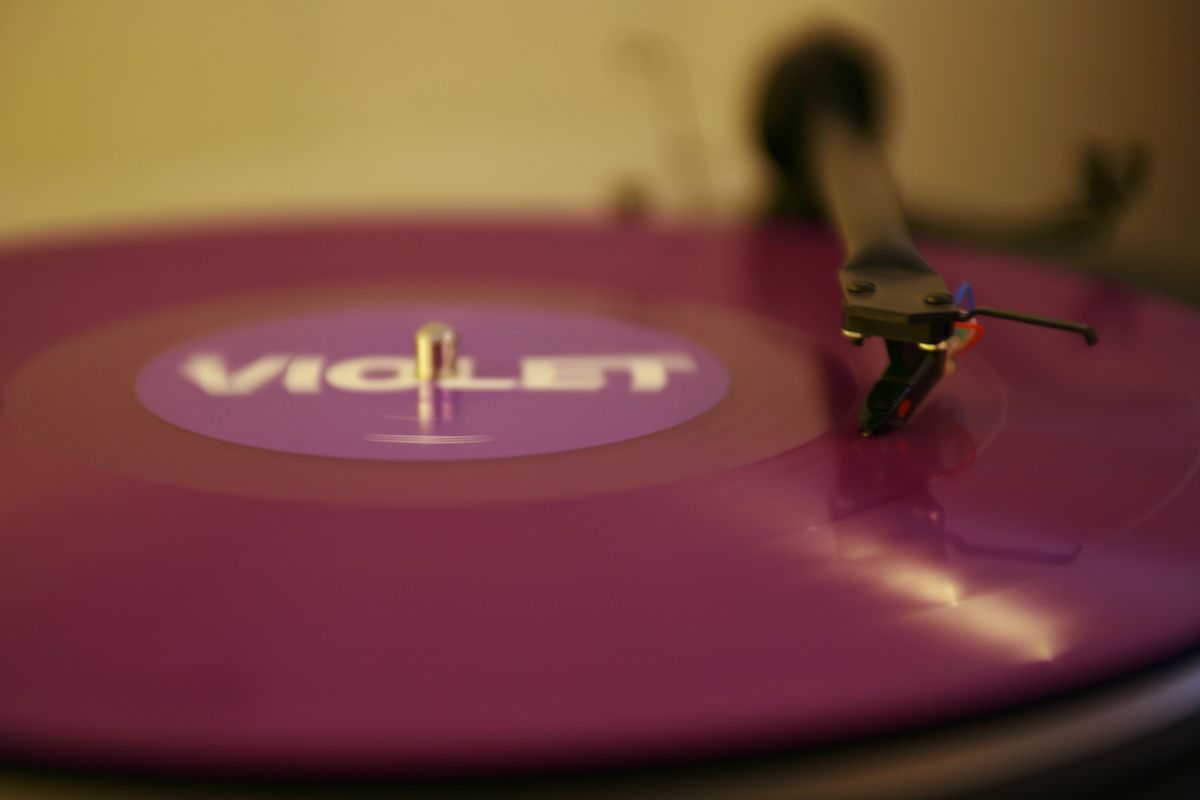 Violet coloured record on a turntable with text Violet on label