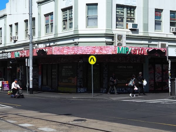 Mipasto, a closed pizza shop on a street corner.